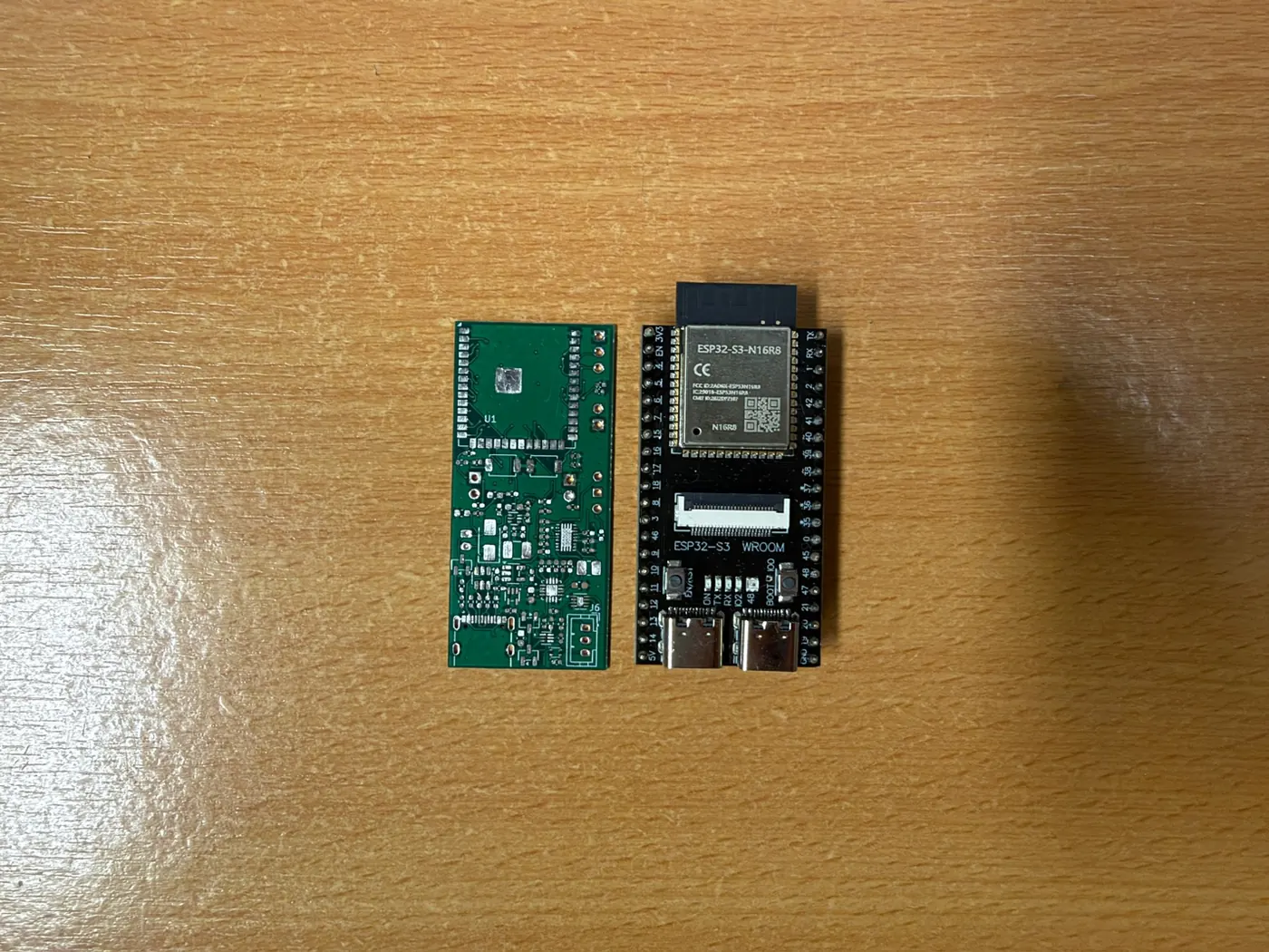 The Prototype V2 PCB lying next to an ESP32-S3 development board of nearly the same size